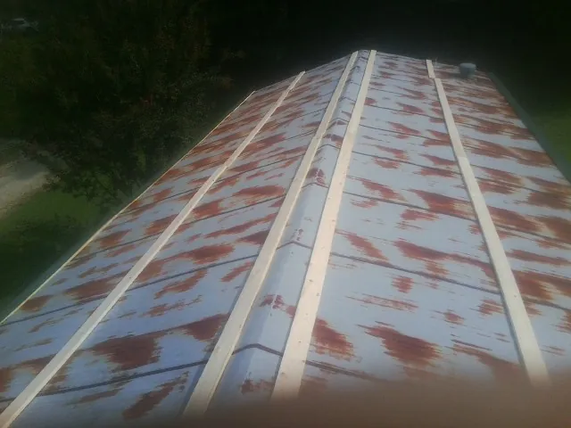 Rusted metal roof panels with new wood purlins before replacement — Storm Damage Roof Repair in Deal by Roofing Brothers